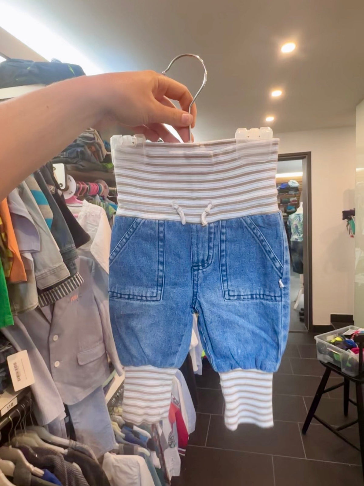 Babyjeans mit gestreiftem Bund am Bügel im Laden